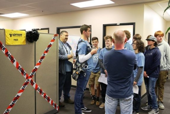 A student tries on a climbing harness. Tower climbers wear safety harnesses when installing and repairing obstruction lights.