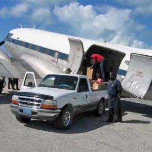 Unloading solar airfield lights at Sandy Point Airport in the Bahamas